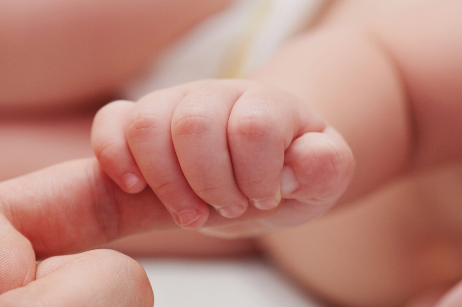 Small,Baby,Hand,Hold,Father,Finger,Close,Up,View